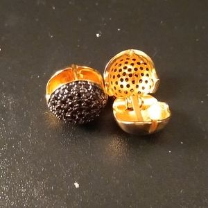 Pave faux black diamonds and gold earrings .